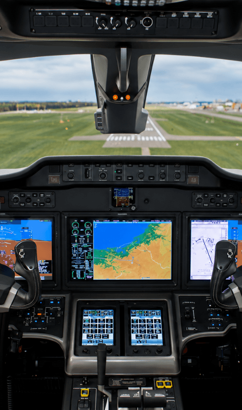 View through a business jet cockpit toward the runway